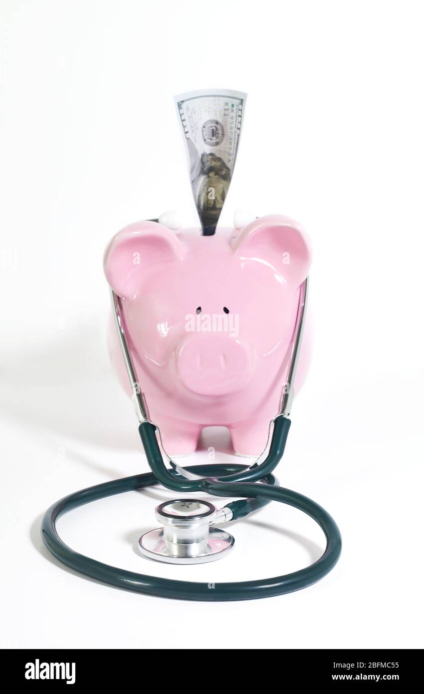 Piggy bank with stethoscope on white background Stock Photo