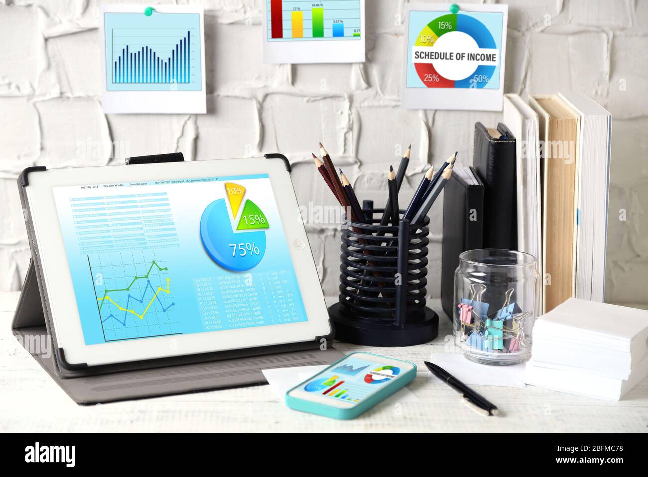 Workplace with tablet-pc with scheme on screen Stock Photo