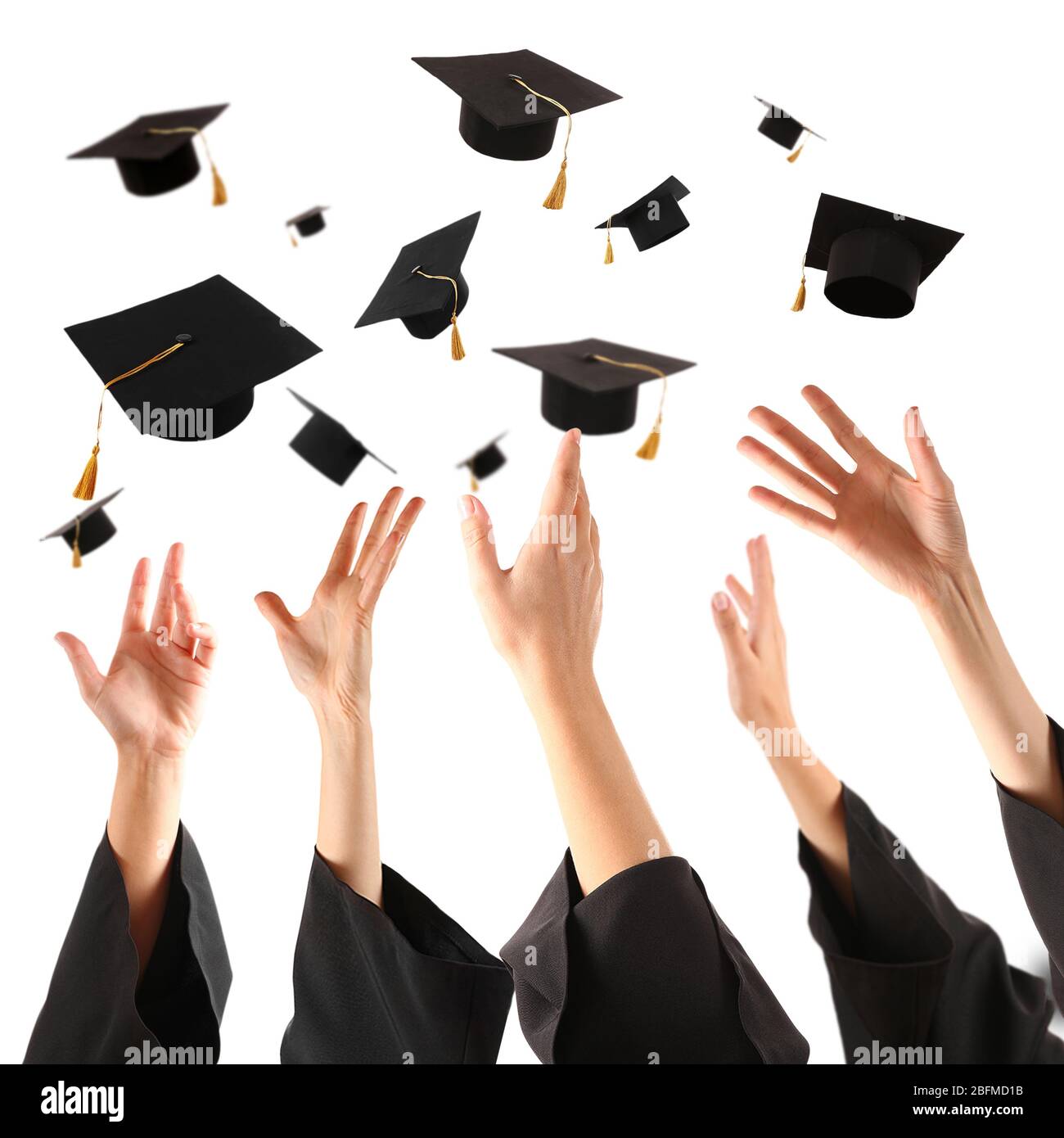 Graduates hands throwing graduation hats , isolated on white Stock