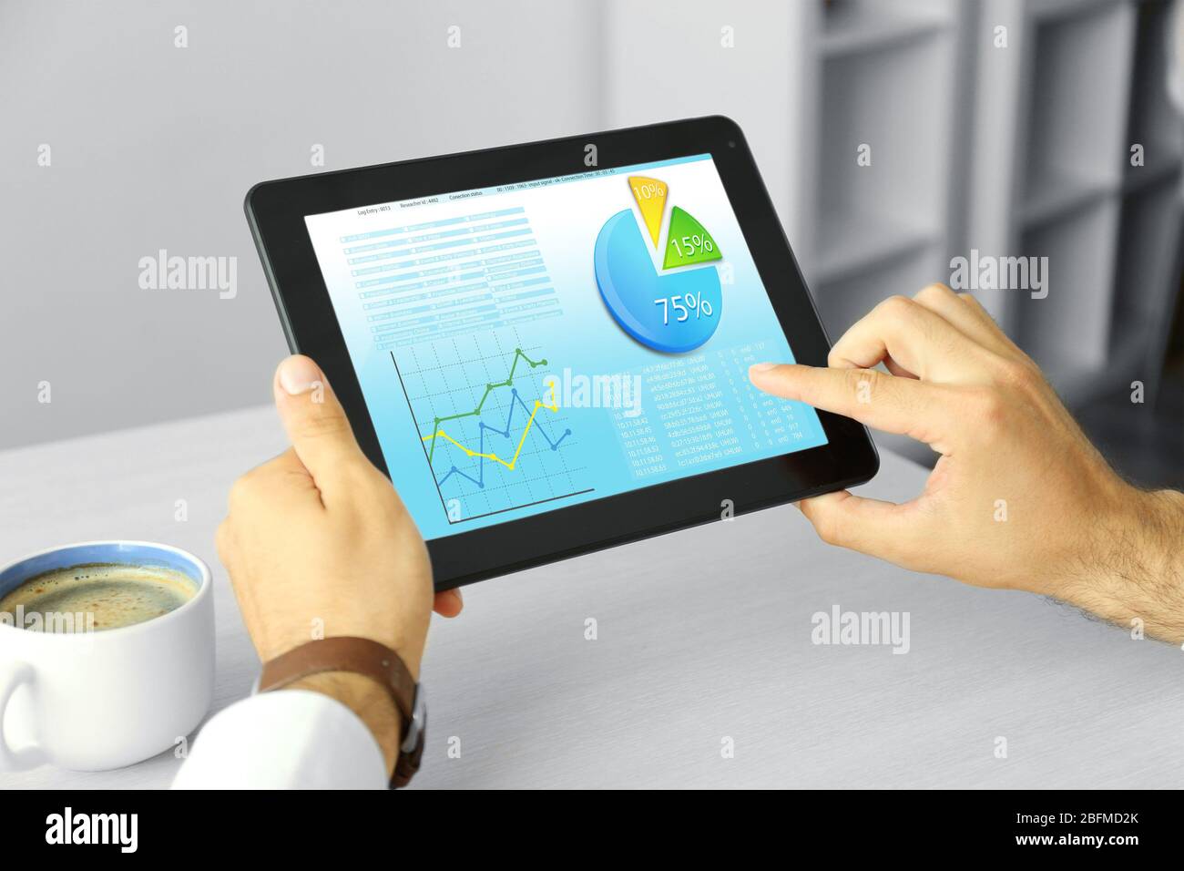 Businessman holding tablet-pc with scheme on screen Stock Photo