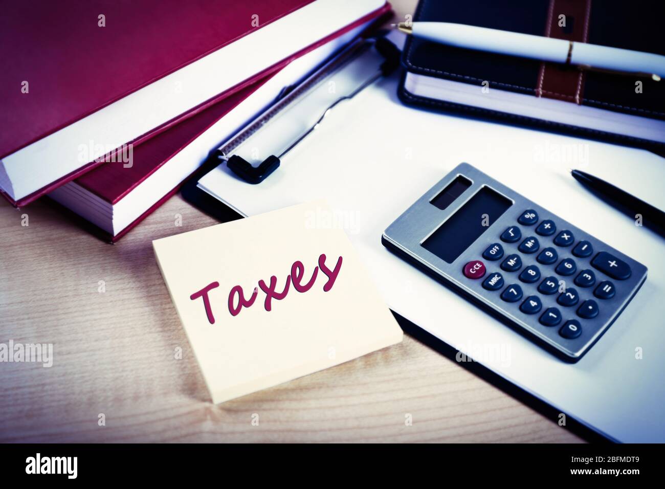 Taxes folder with office tools on the table Stock Photo - Alamy