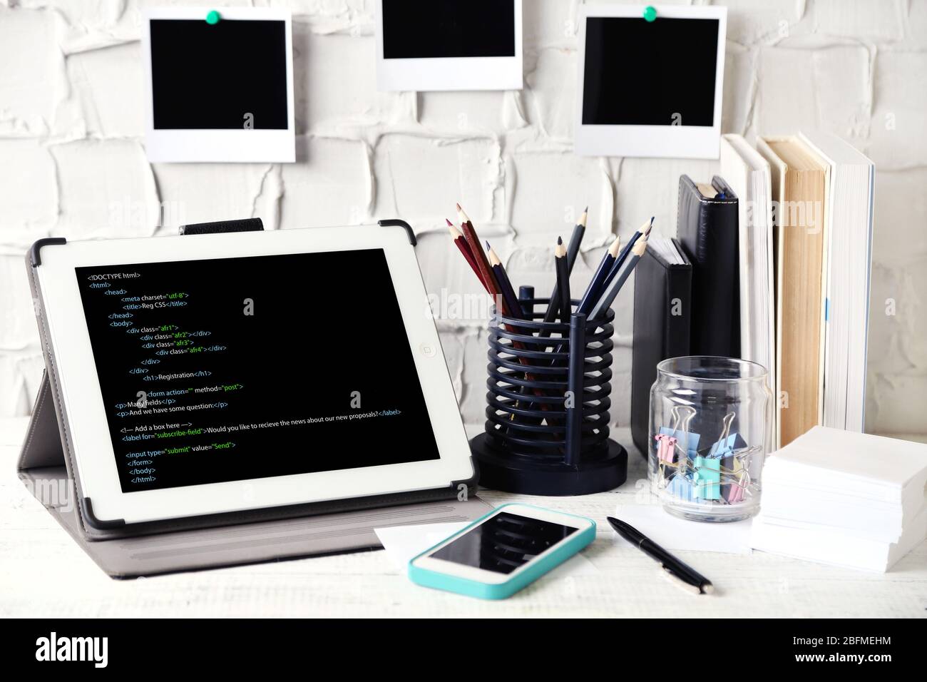 Programming code on tablet computer monitor Stock Photo - Alamy