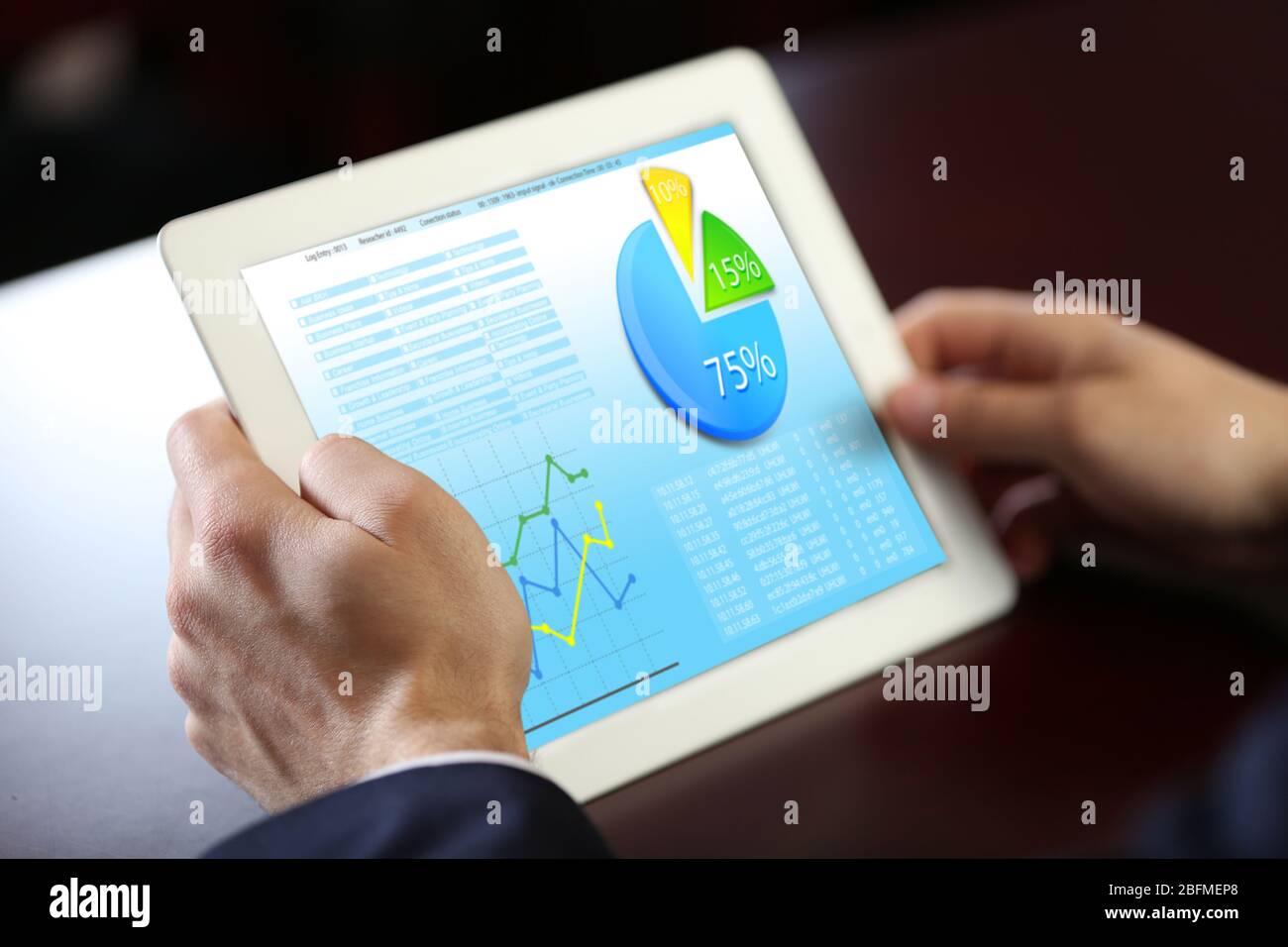 Businessman holding tablet-pc with scheme on screen Stock Photo
