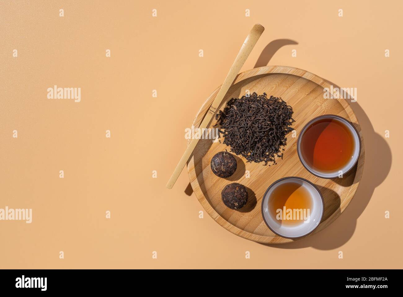 Two Ceramic Bowls With Black Puer Tea Dry Pu Erh Tea Leaves In A Wooden Bamboo Plate On A Beige Background Stock Photo Alamy Two Ceramic Bowls With Black Puer Tea Dry Pu Erh Tea Leaves In A Wooden Bamboo Plate On A Beige Background Stock Photo Alamy