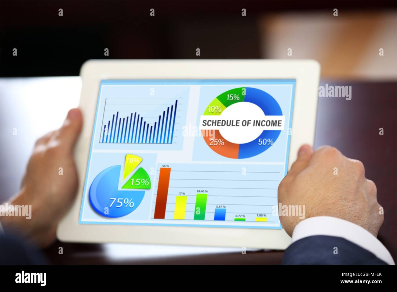 Businessman holding tablet-pc with scheme on screen Stock Photo