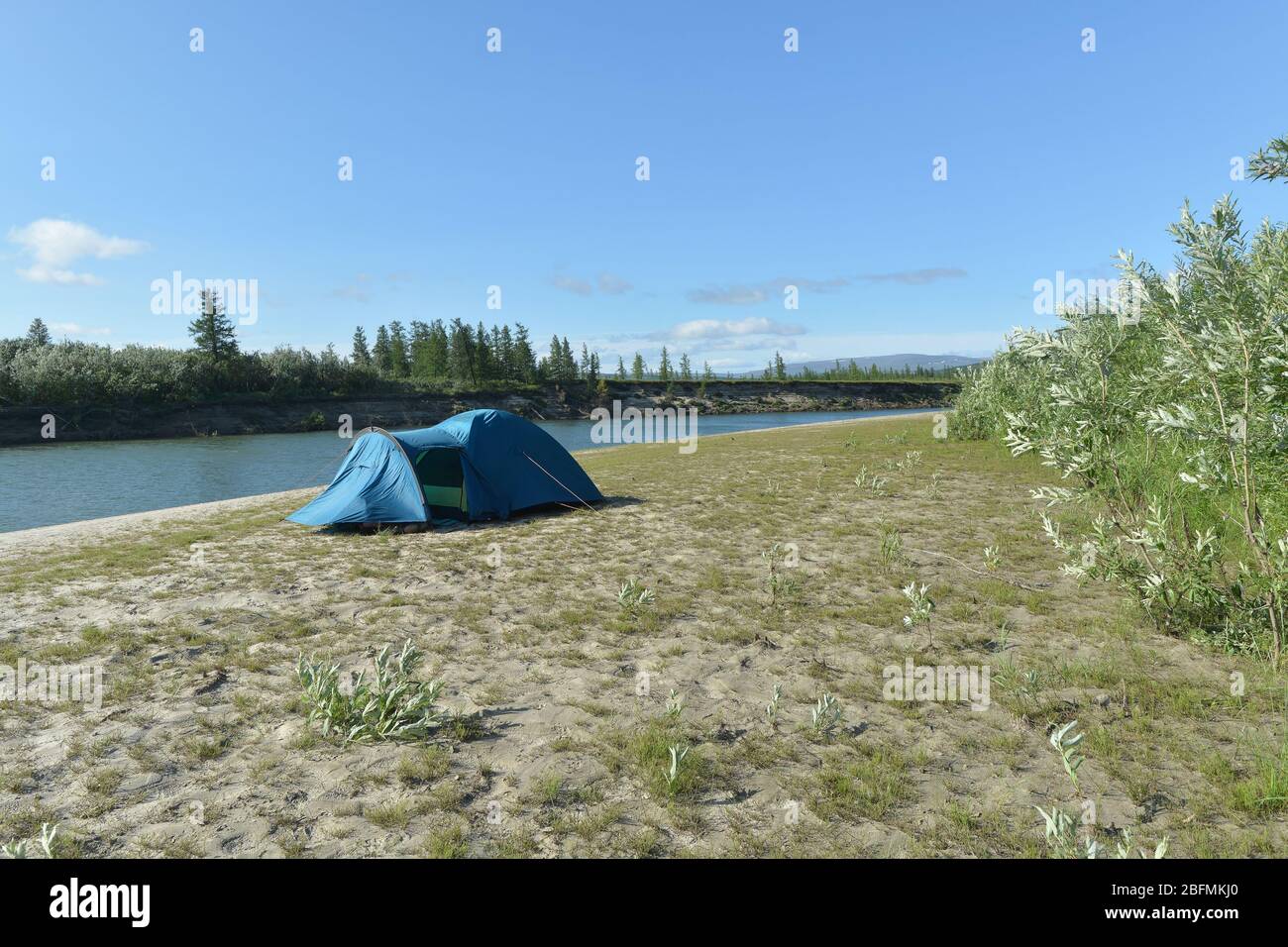 Tent on the banks of the river in Yamal. Summer trip to the Polar-Ural Natural Park. Stock Photo