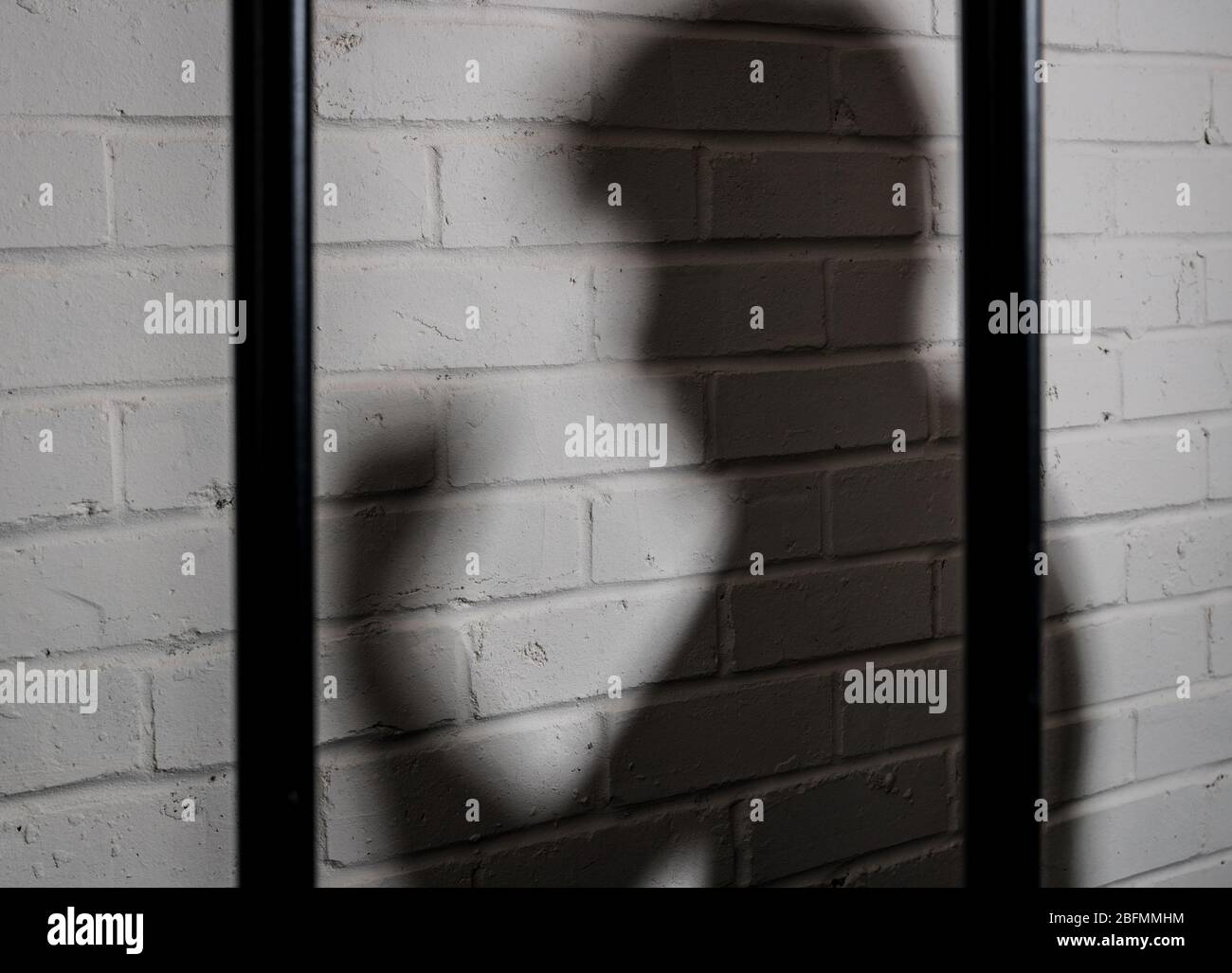 Shadow of a violent prisoner, prison abuse concept image Stock Photo