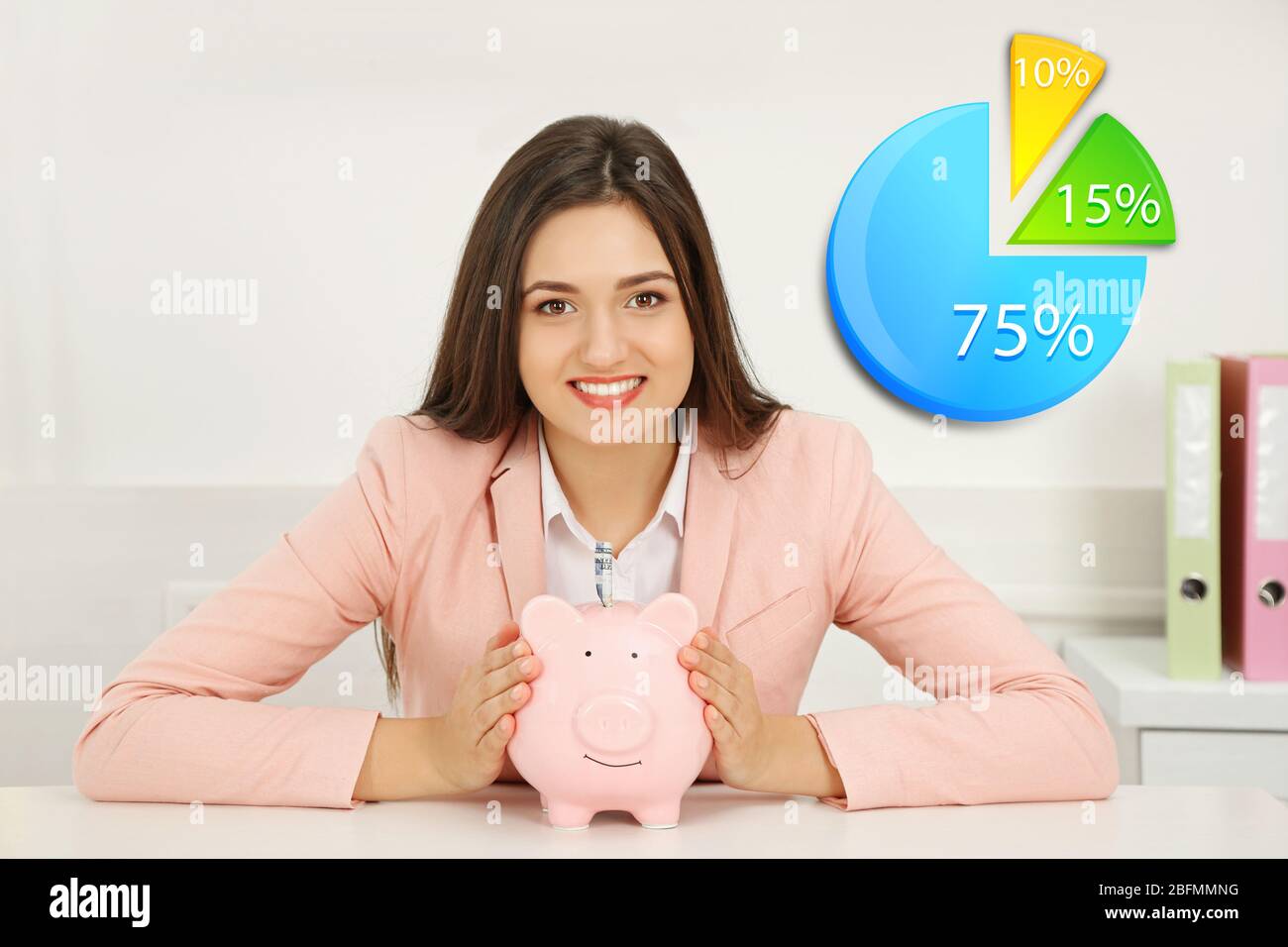 Business accounting concept. Happy young woman holding piggy bank with ...