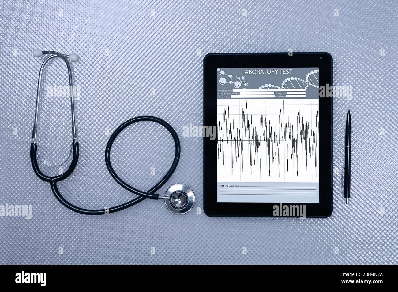 Medical tablet with stethoscope on grey background Stock Photo - Alamy