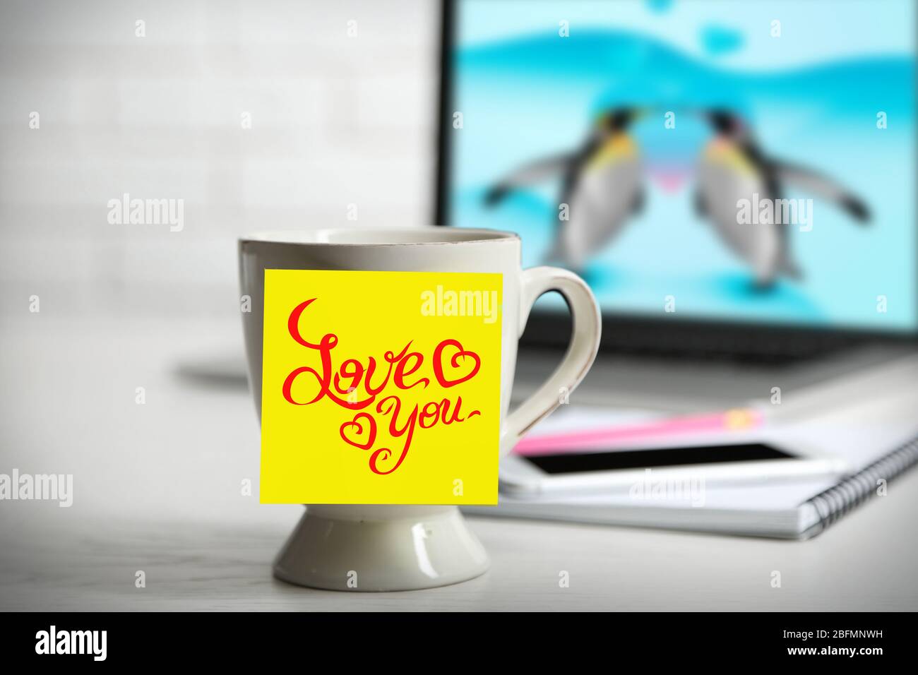 https://c8.alamy.com/comp/2BFMNWH/yellow-adhesive-note-with-drawings-on-coffee-cup-on-laptop-background-2BFMNWH.jpg