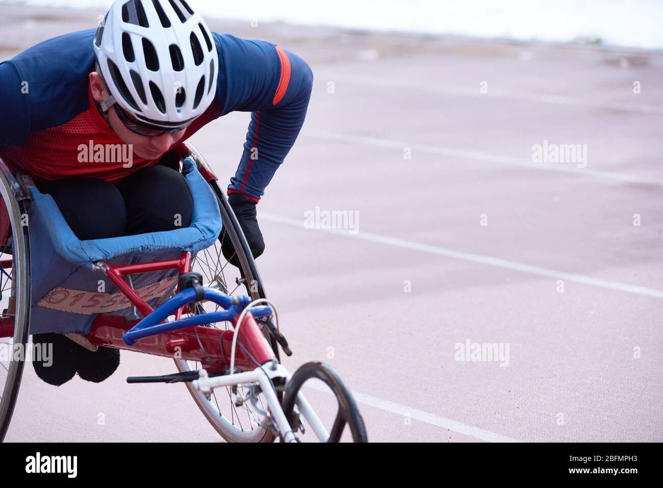 Determined handicapped male athlete in helmet racing in specialized