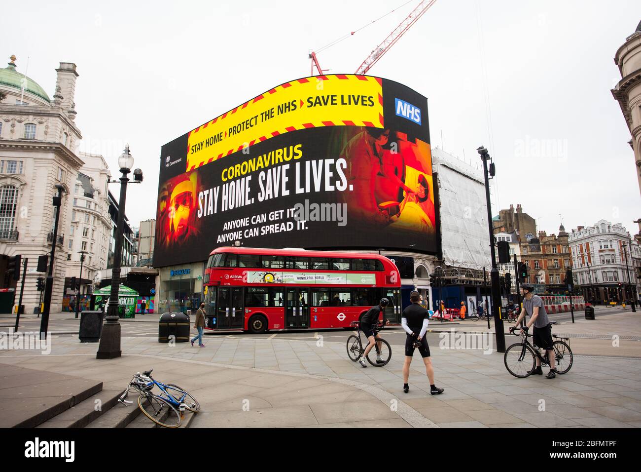 Stay Home. Protect the NHS. Save Lives. A message from the british government is displayed on the advertising screen in piccadilly circus, central Lon Stock Photo