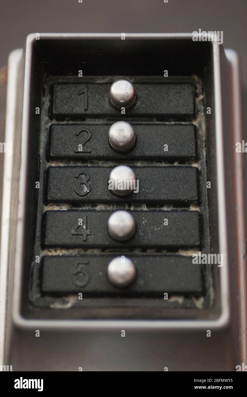 Close up of a dirty door lock metal keypad. Macro view of the buttons and digits of a doorlock keypad. Stock Photo