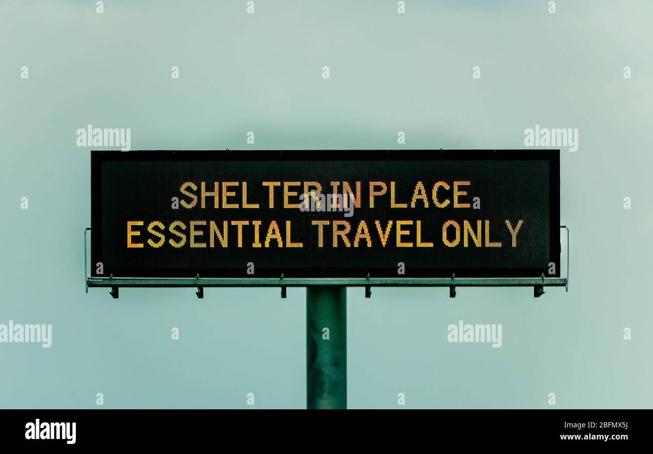 An electronic sign on Interstate 10 West warns motorists of Mississippi’s shelter in place order during the COVID-19 pandemic. Stock Photo