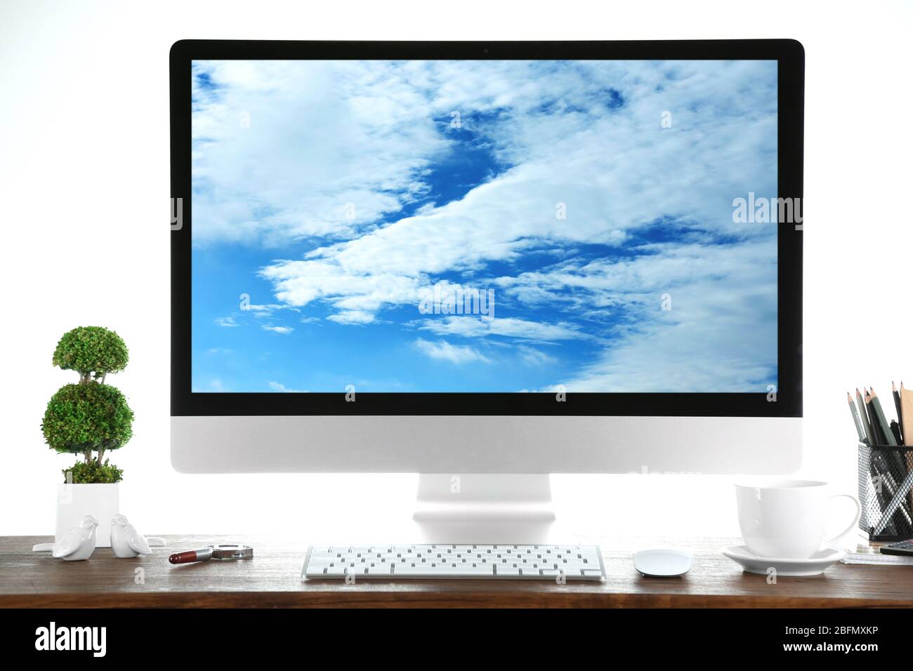 Computer on wooden table with white background. Cloud storage concept Stock Photo