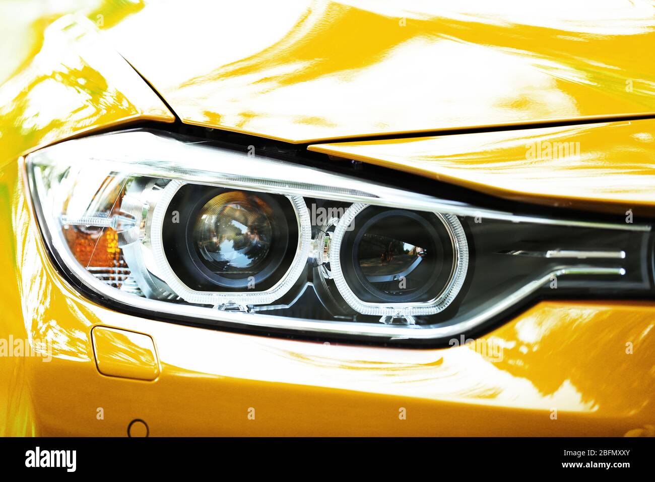 Headlights of yellow car Stock Photo Alamy