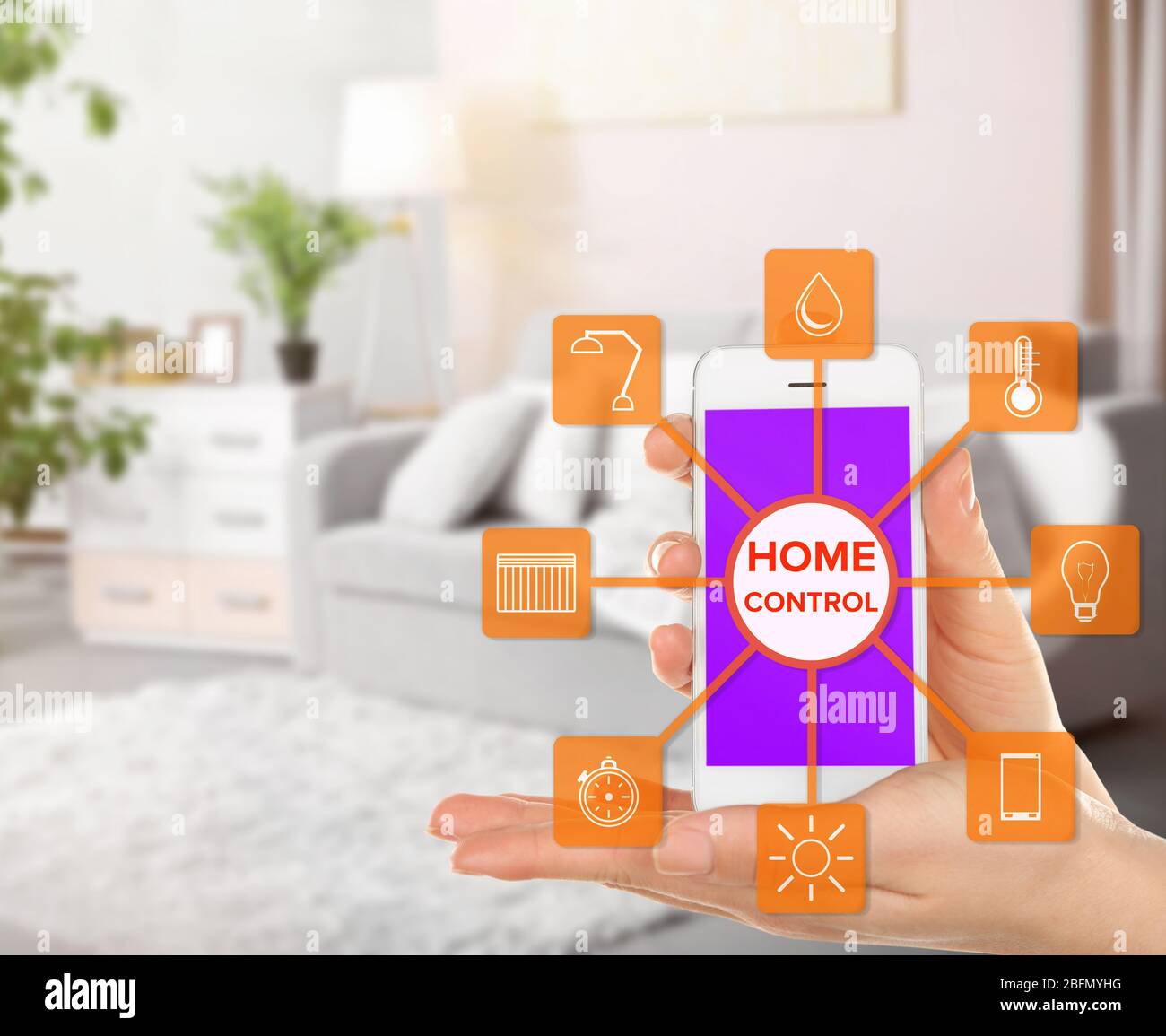 Using smart home app on phone. Smart home control concept. Stock Photo