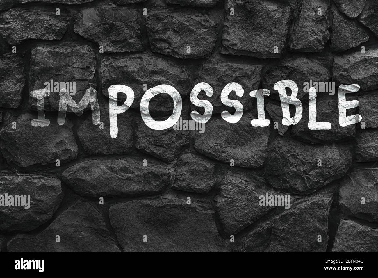Word impossible transformed into possible on grey wall Stock Photo