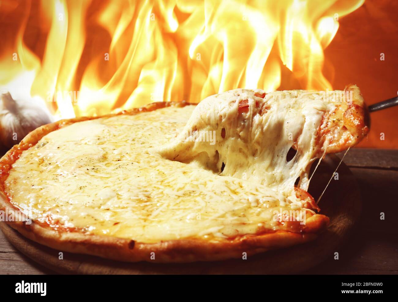 Tasty Sliced Pizza On Fire Flame Background Stock Photo Alamy