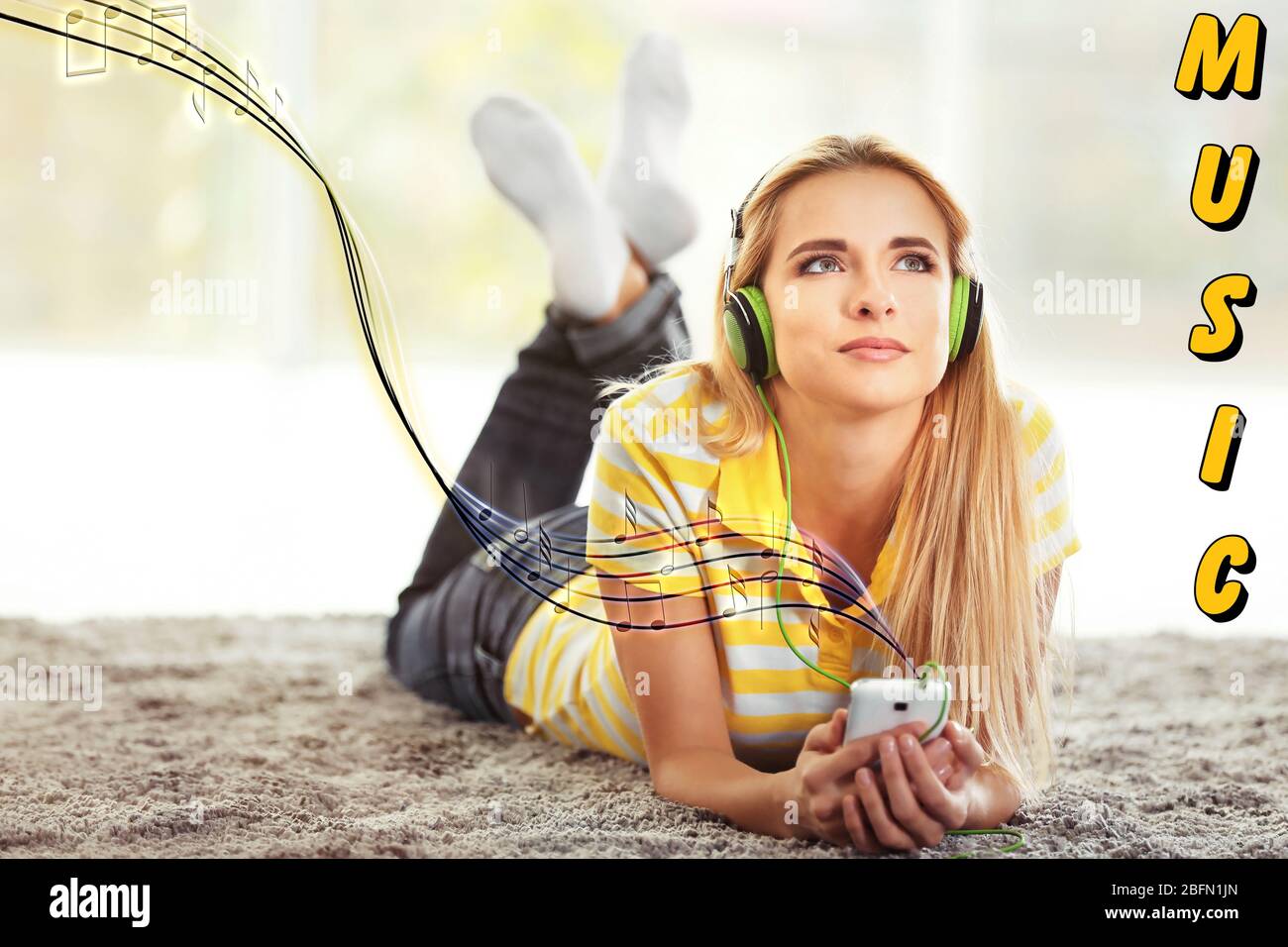 Young woman listening to music on the floor in a room Stock Photo - Alamy