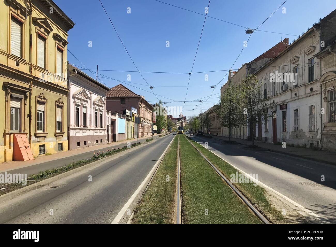 Szeged, Hungary, April 11: View of a deserted street during a coronavirus quarantine in the city of Szeged on a Sunny spring day, April 11, 2020. Stock Photo