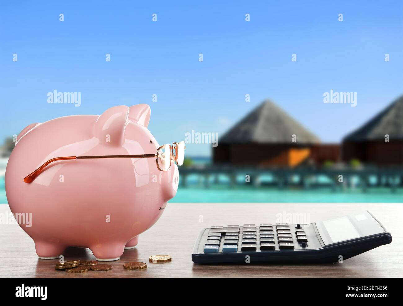 Pink piggy bank with glasses and calculator on resort background Stock ...