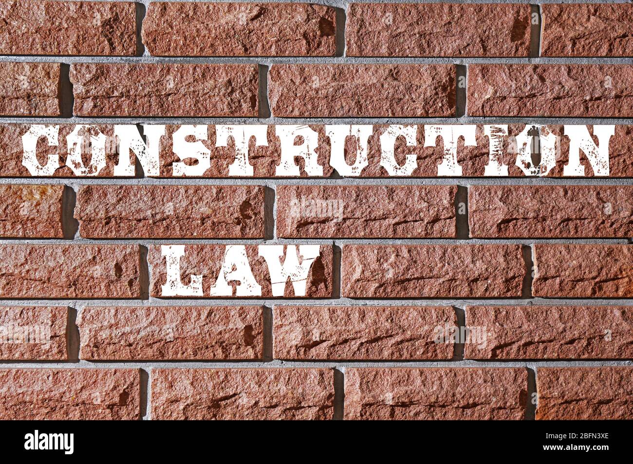 'Construction Law' text on brick wall Stock Photo