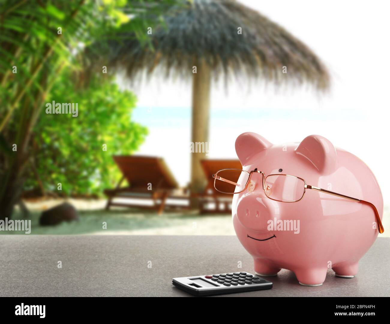 Pink piggy bank with glasses and calculator on resort background Stock ...