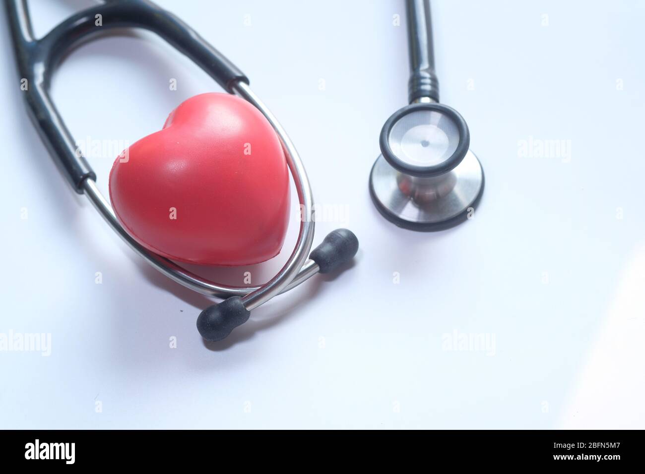 Red heart and a stethoscope on a white background Stock Photo - Alamy