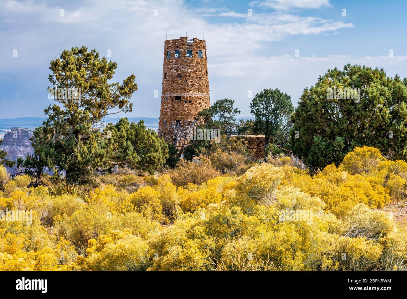 Grand Canyon Desert View Watchtower in autumn with ericameria nauseosa, located on the south rim of Grand Canyon National Park, Arizona. Stock Photo