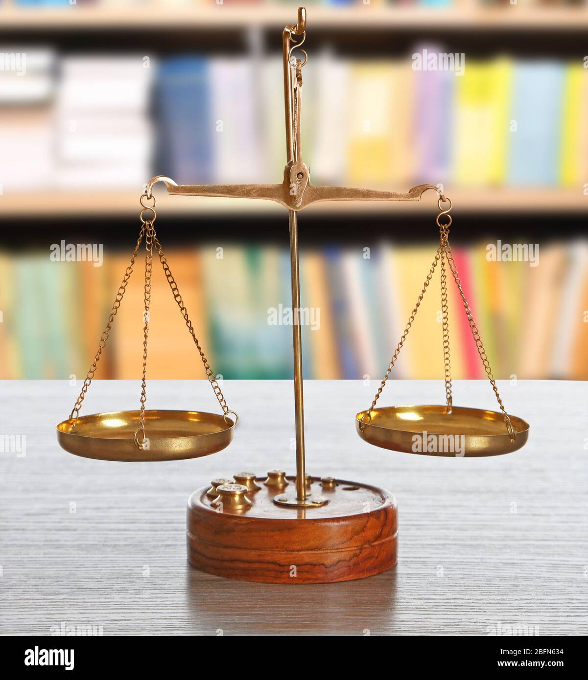 Justice scales on table in library Stock Photo - Alamy