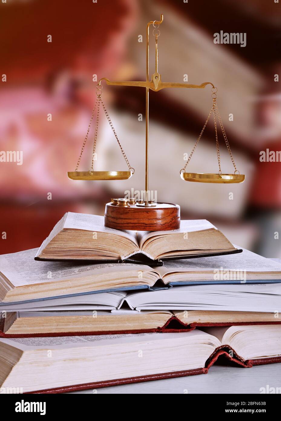 Justice scales with books on table in library Stock Photo Alamy