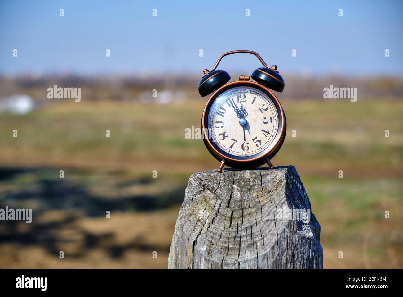 Old retro alarm clock in nature Stock Photo - Alamy