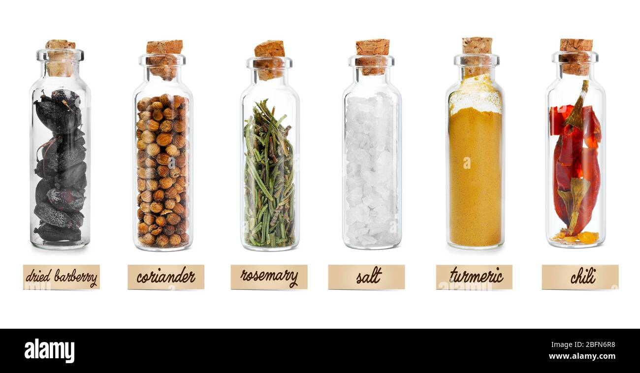 Set of different spices in glass jars. Isolated on white Stock Photo
