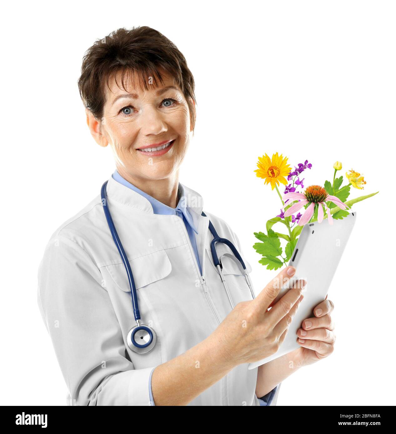 Female doctor with tablet and flowers bouquet on white background. Alternative medicine concept