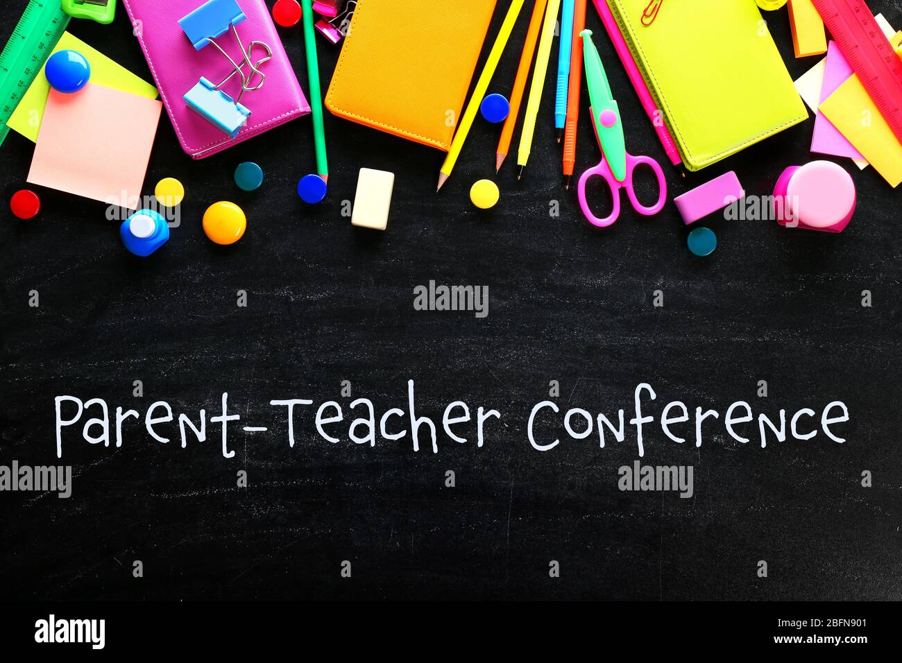 Text PARENT-TEACHER CONFERENCE with stationary on blackboard background. School concept. Stock Photo