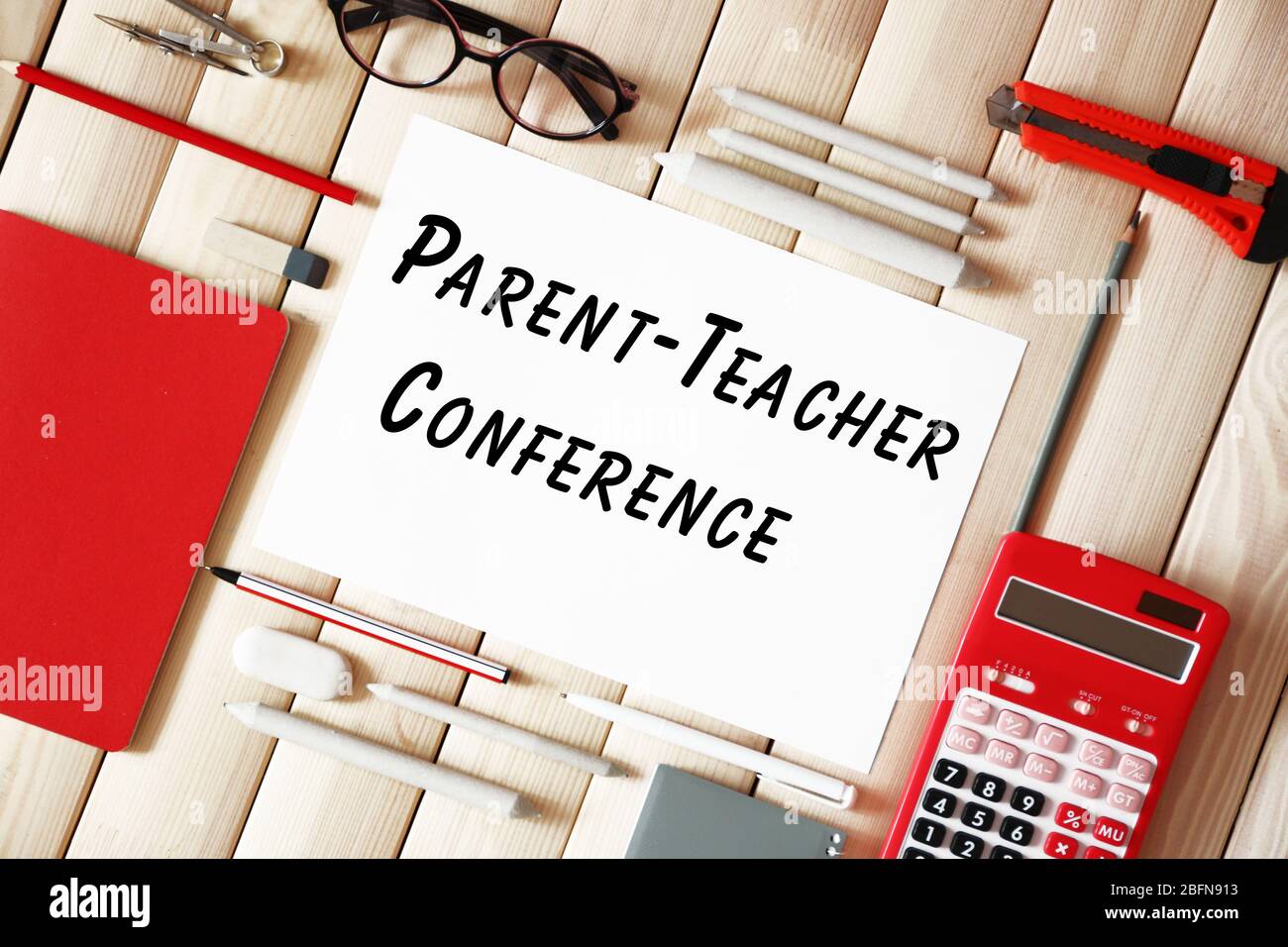 Sheet of paper with text PARENT-TEACHER CONFERENCE and stationery on wooden background. School concept. Stock Photo