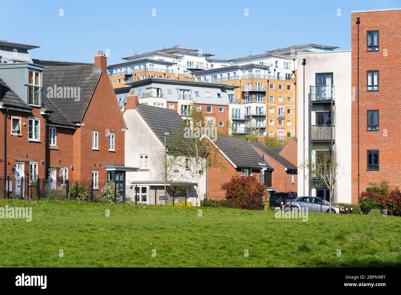Mixed terraced houses, semi detached housing and flats at Sinclair Drive and Winterthur Way in Basingstoke town centre, Basingstoke, Hampshire, UK Stock Photo
