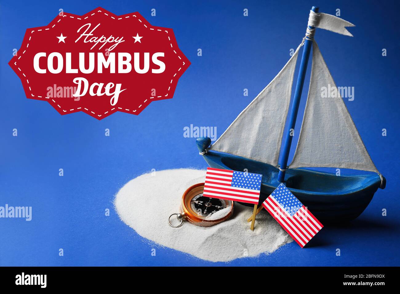 Text HAPPY COLUMBUS DAY with wooden boat and compass on blue background. National holiday concept. Stock Photo