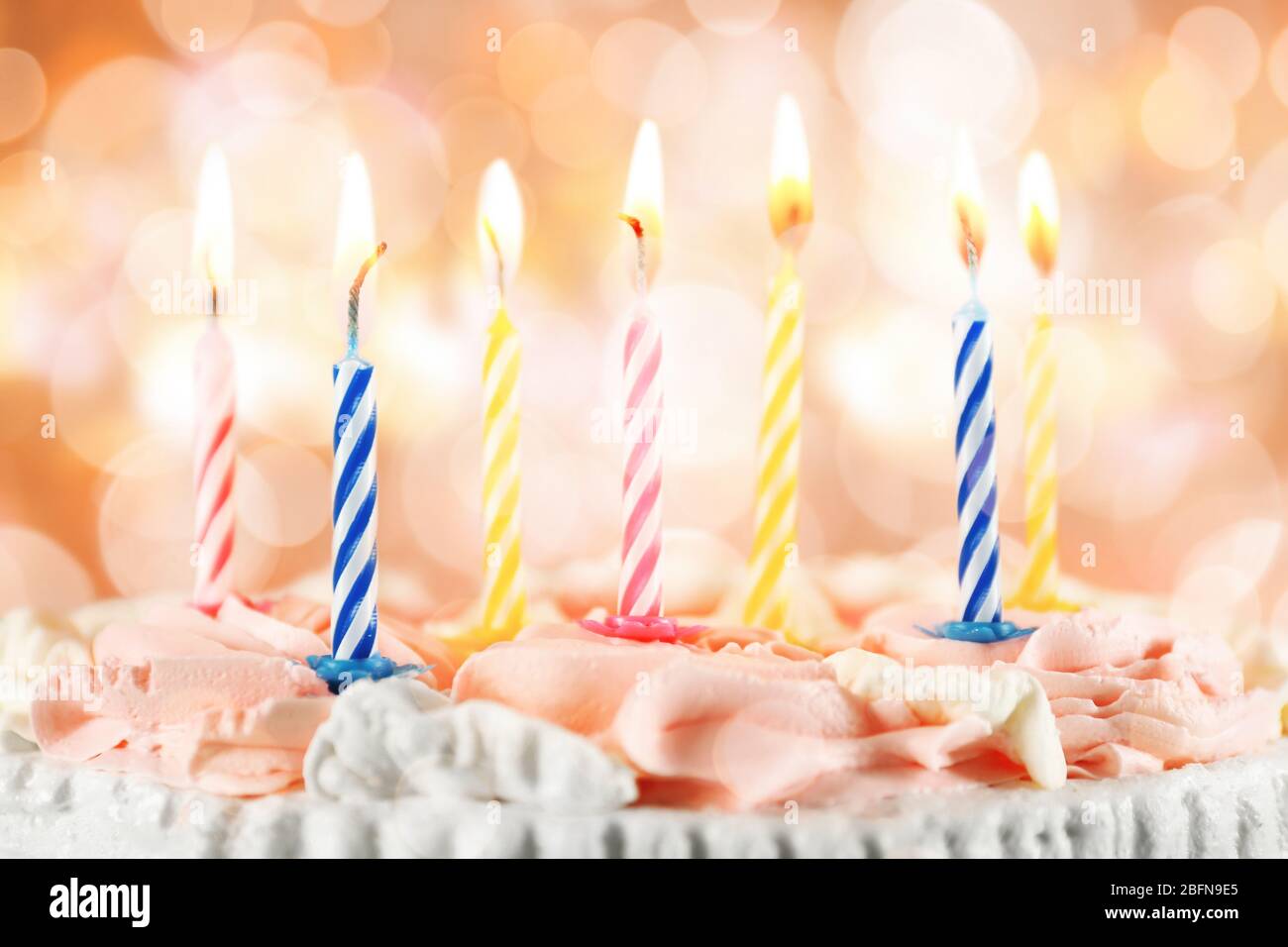 Lighted candles on birthday cake, closeup Stock Photo Alamy