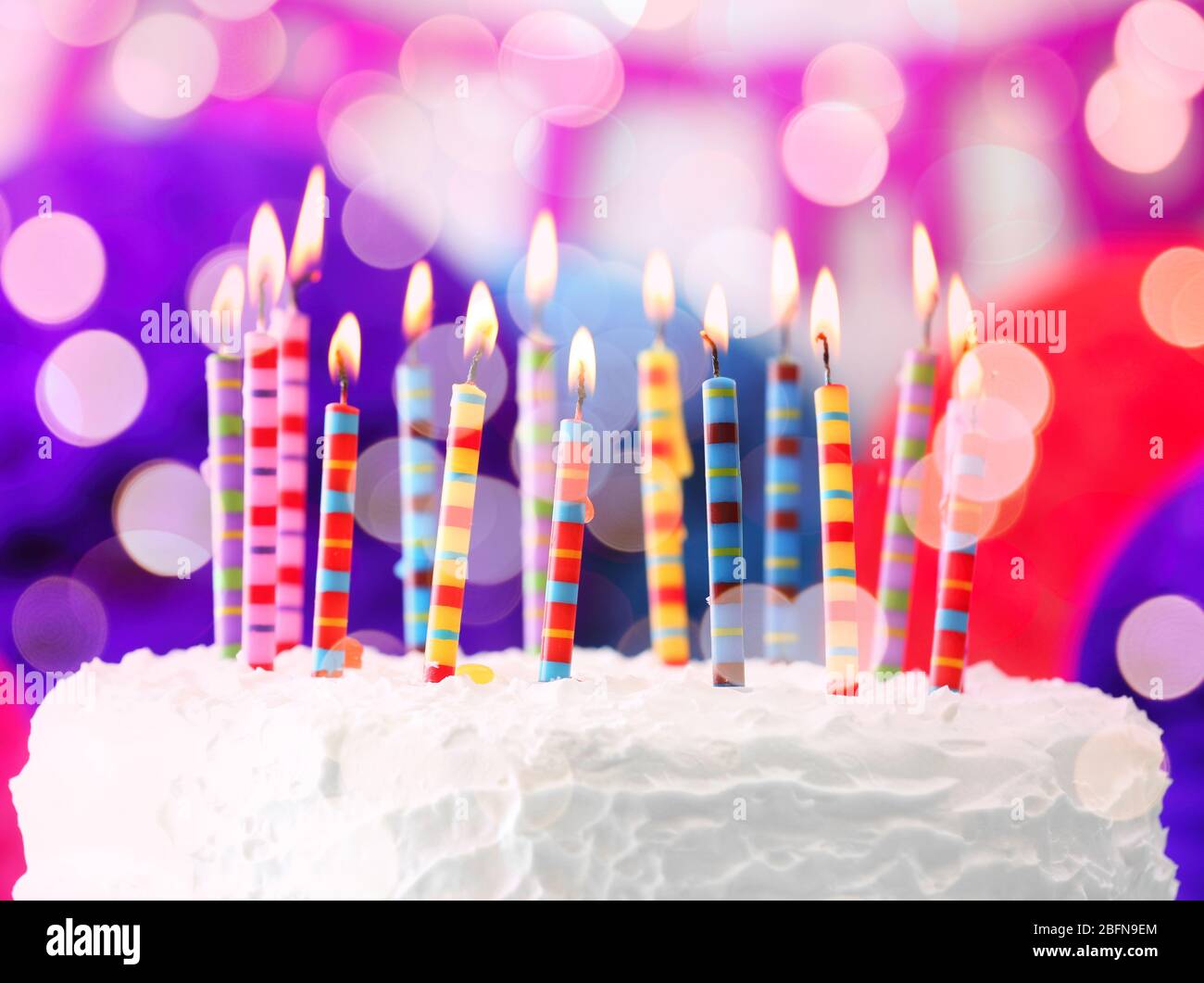 Lighted candles on birthday cake, closeup Stock Photo Alamy