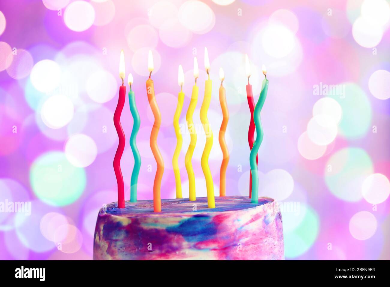 Lighted candles on birthday cake, closeup Stock Photo - Alamy