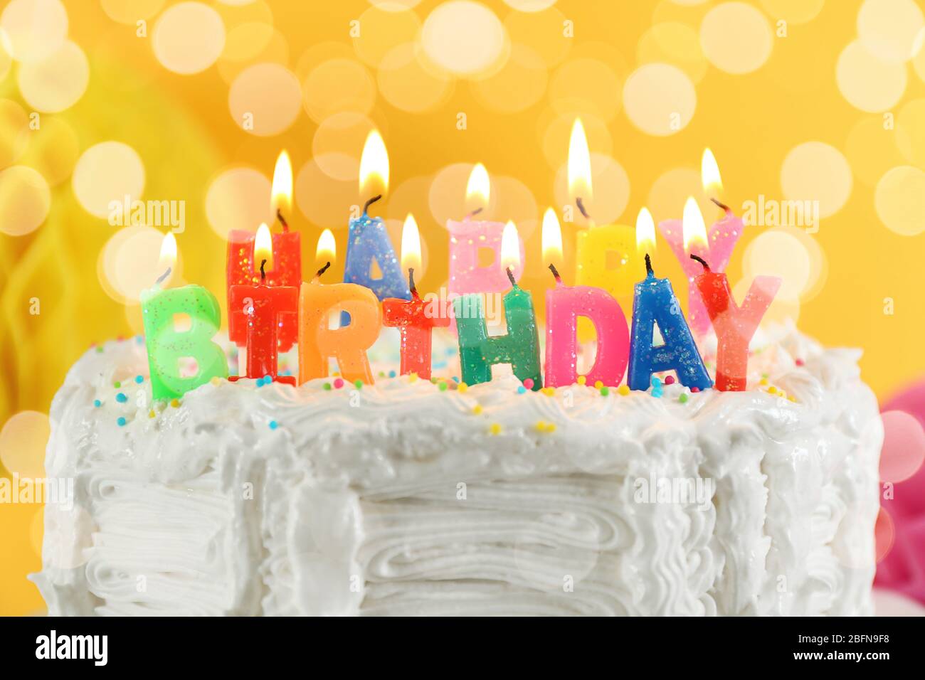 Lighted candles on birthday cake, closeup Stock Photo - Alamy