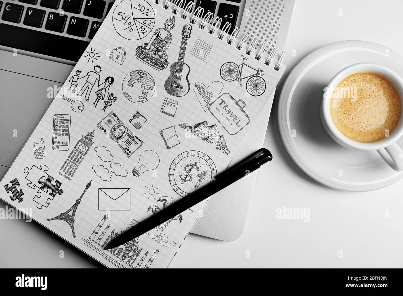 Notebook with drawings and cup of coffee on table. Creative concept. Stock Photo