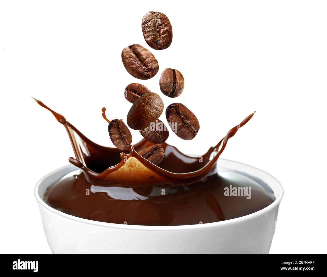 Roasted coffee beans falling into cup, white background Stock Photo - Alamy