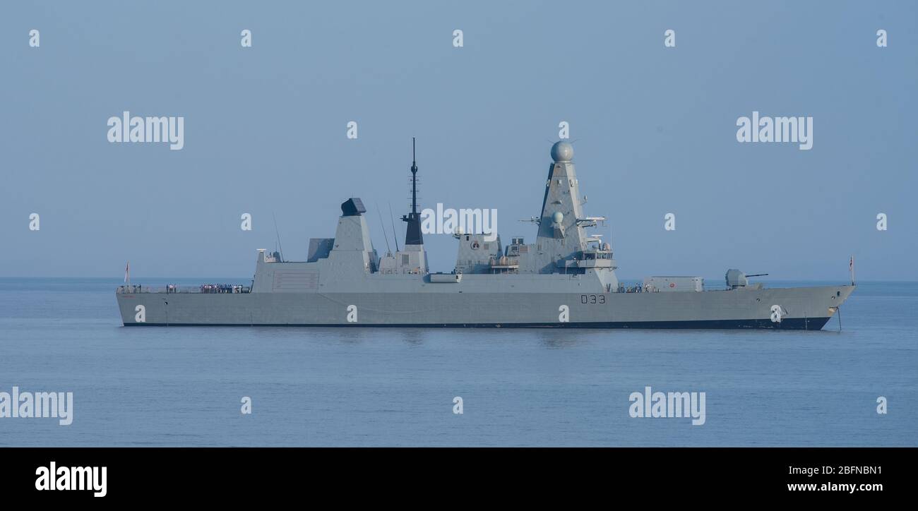Lyme Regis, Dorset, UK. 19th Apr, 2020. UK Weather: Royal Navy Type 45 Destroyer HMS Dauntless observes social distancing on a warm and sunny afternoon during the coronavirus lockdown. An announcement was heard reminding the ship's company to stay 2 meters apart when on deck. Credit: Celia McMahon/Alamy Live News Stock Photo