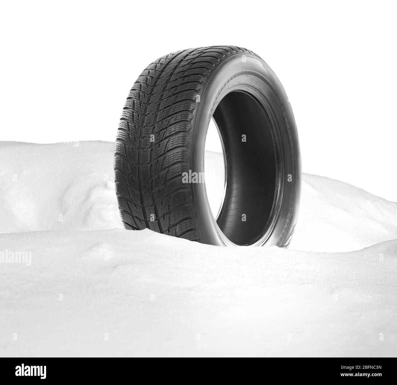 Car tire in snowdrift on white background. Winter tires concept Stock