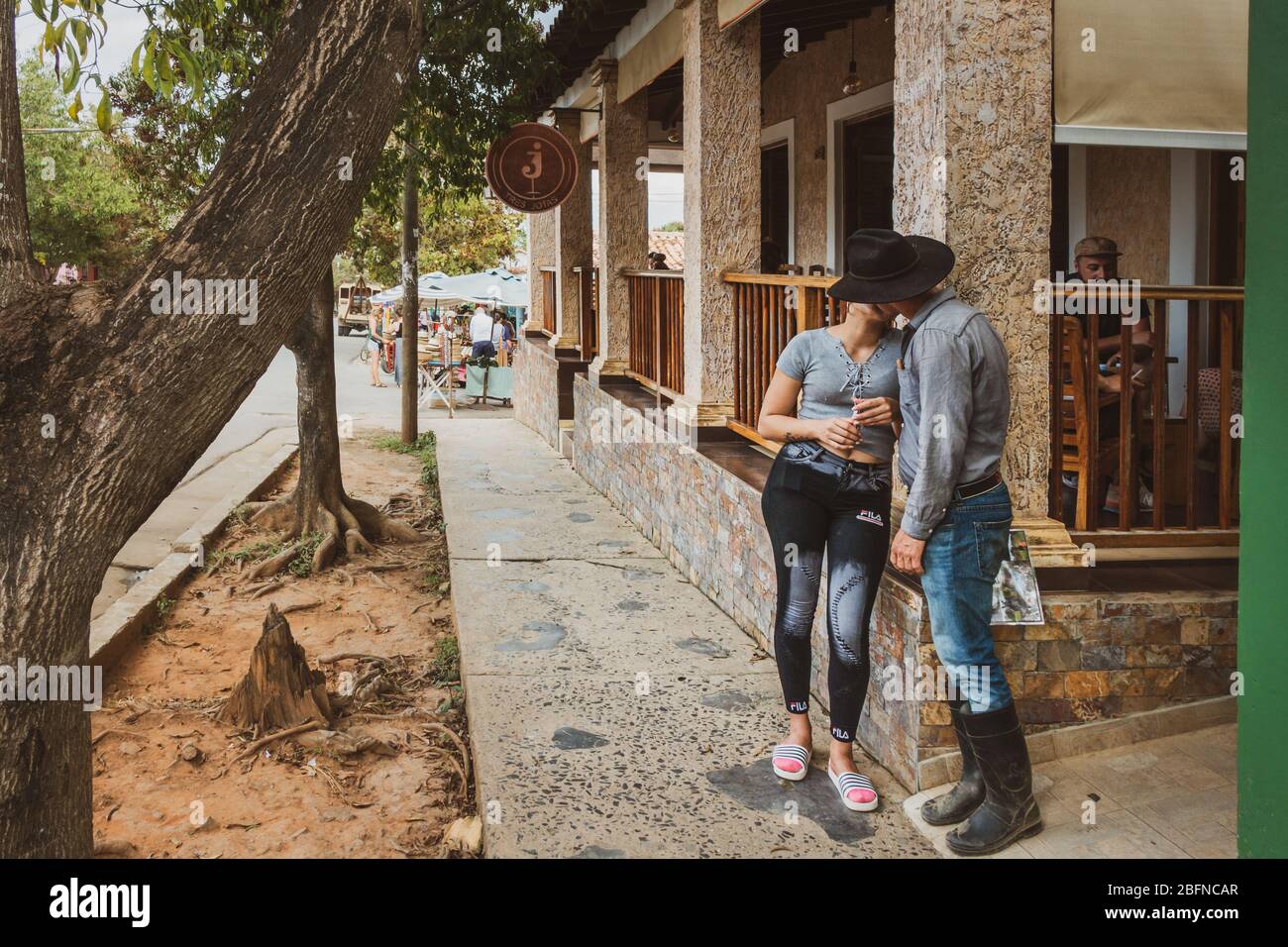 Cuban local couple kissing outside 3J's cafe (Tres Jotas), Vinales, Cuba Stock Photo