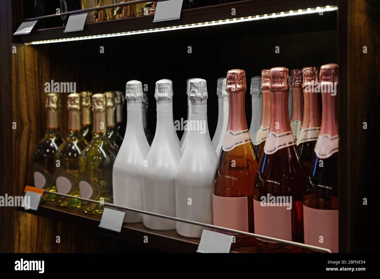 Wine Bottles On Wooden Shelf At Liquor Store Stock Photo