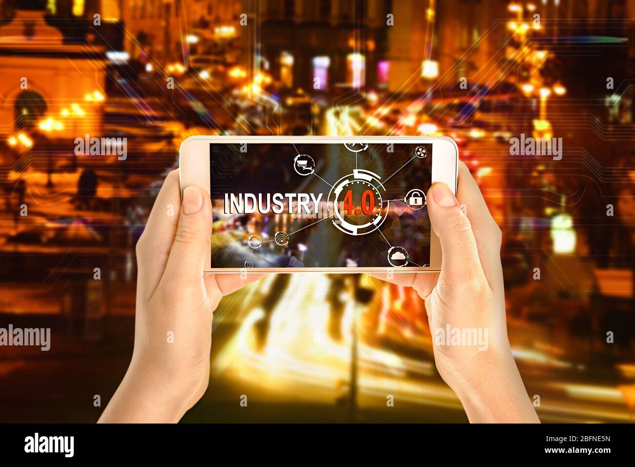 Female hands with smartphone on cityscape background. Text INDUSTRY 4.0 on screen Stock Photo